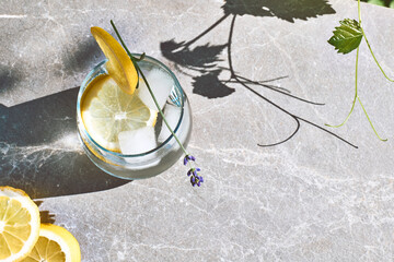 Cool lavender homemade lemonade with lemon slices and lavender flower. Healthy organic summer soda...