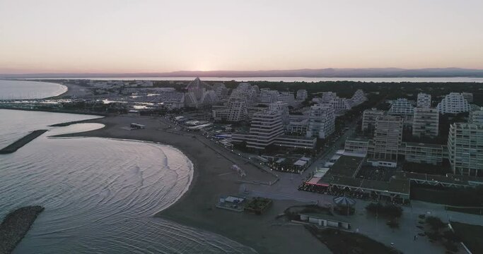 Aerial View of La Grande-Motte popular seaside resort and port. Sunset footage