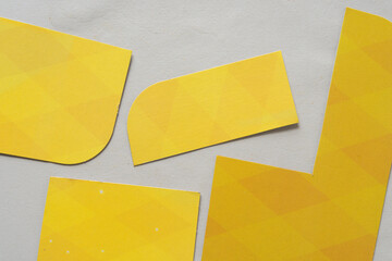 pieces of a yellow cardboard box with pattern on old art paper - viewed from above