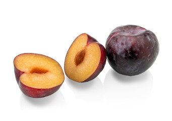 Naklejka na ściany i meble Black plums isolated on white, one whole and one cut in half. Clipping path