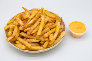 Parmesan Truffle Fries on a Plate with a Side of Sauce and a White Background