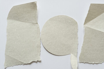 three abstract paper shapes on a light background