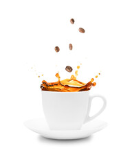 Coffee spills out of a cup and saucer on a white background with coffee grains.