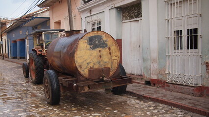 Tractor water carrier on city street, Trinidad, Cuba