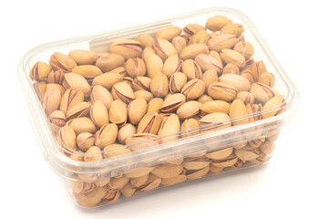 Packed pistachio nuts isolated on white background. Organic nuts. close up