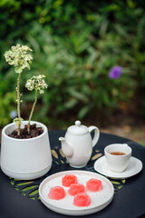 Pink jelly desserts with a set of tea on the table. (selective focus)