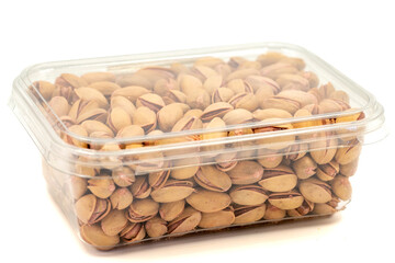 Packed pistachio nuts isolated on white background. Organic nuts. close up