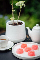 Pink jelly desserts with a set of tea on the table. (selective focus)