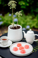 Pink jelly desserts with a set of tea on the table. (selective focus)
