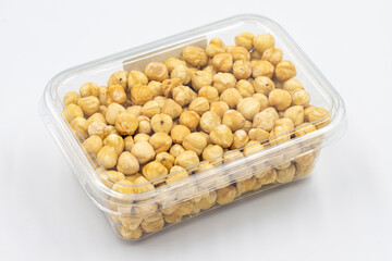 Roasted hazelnut nut in package isolated on white background. Organic nuts. close up