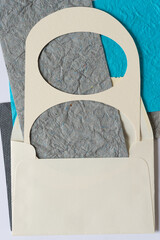 paper stencil with paper shapes tucked inside a paper envelope
