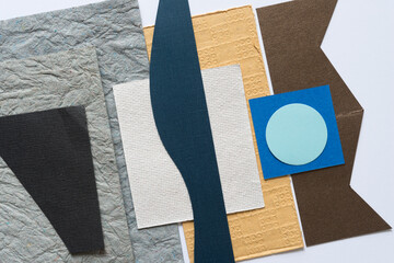 paper shapes (blue circle and brown zig zag)
