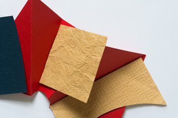 blue, red, and yellow ochre paper with texture viewed from above