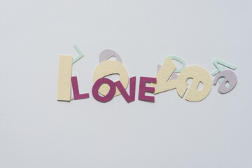 love (the word) spelled on in various type fonts on a light background with space