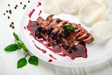 Sliced beef steak with berry sauce