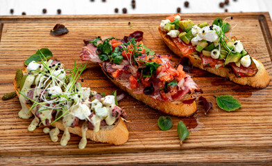 Assorted bruschetta with various toppings.
