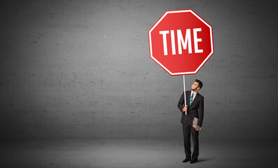 Young business person holding road sign