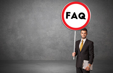 Young business person holdig traffic sign
