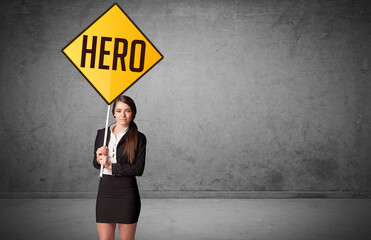 Young business person holding road sign