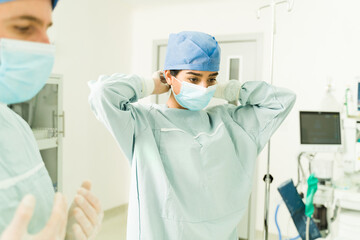 Female surgeon preparing for surgery