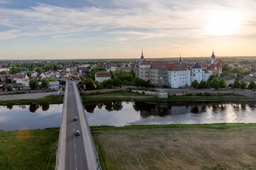Bridge over the river Elbe and Hartenfels castle in the town of Torgau from above. Saxony. Germany