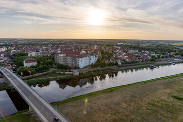 Bridge over the river Elbe and Hartenfels castle in the town of Torgau from above. Saxony. Germany