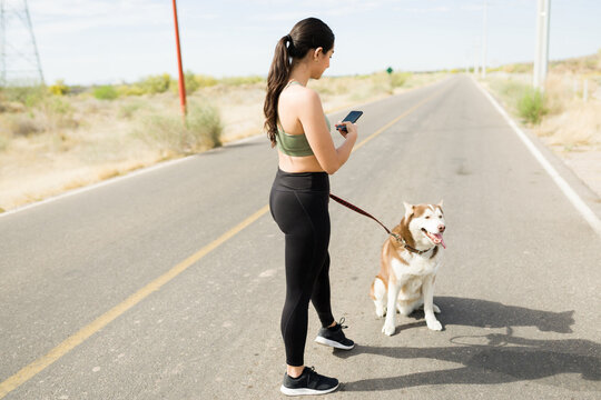 Attractive woman enjoying exercising with her dog