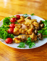 Grilled chicken on bamboo skewers, close up view