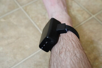 House arrest GPS jail monitoring bracelet on the male ankle due to jail sentence.