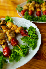 Grilled chicken on bamboo skewers, close up view