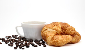 Croissant served with coffee on a white background. There are coffee beans on the ground.