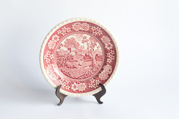 Vintage porcelain plate with red pattern