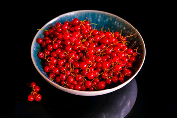 Plate full of ripe Redcurrant berries.