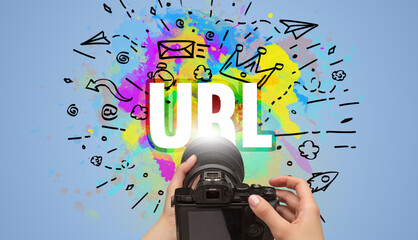 Close-up of a hand holding digital camera with abstract drawing