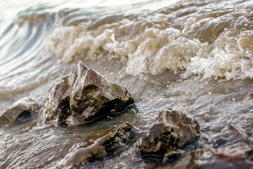background sandy beach with waves and rocks