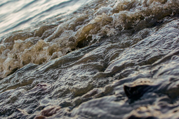 background sandy beach with waves and rocks