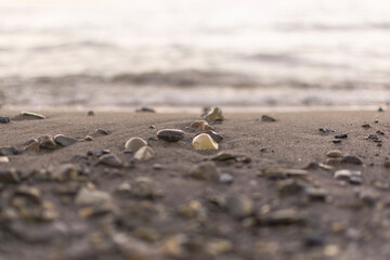 background sandy beach with waves and rocks