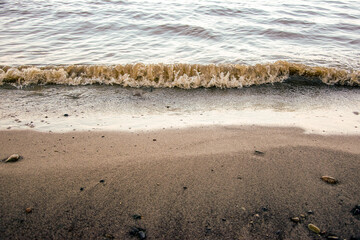 background sandy beach with waves and rocks