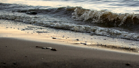 background sandy beach with waves and rocks
