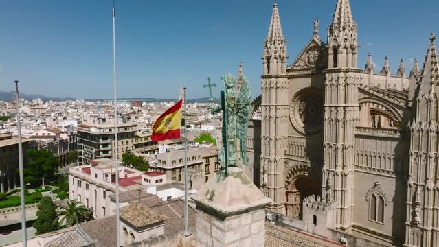 Aerial view of the Spanish flag near the La Seu, the gothic medieval cathedral of Palma de Mallorca in Spain