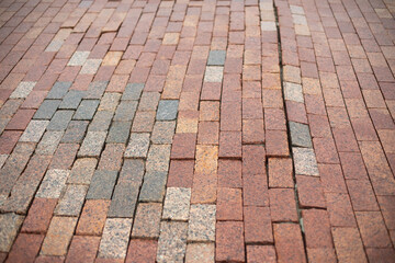 Stonework made of red cobblestones. Details of road.