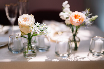Dinner table decorated by candles and flowers. Wedding. Decor