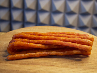 Polish smoked cabanossi sausages on a wooden surface.