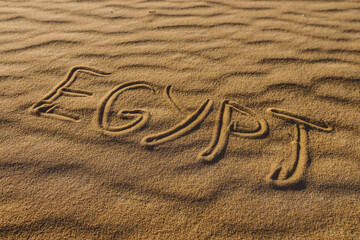 Fototapeta na wymiar Inscription Egypt on the Sandy Surface of the White Desert Protected Area, Farafra Oasis in Egypt