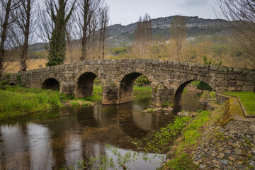 Fototapeta na wymiar Old roman stone bridge over Sever river in Portagem - Marvão, Portugal