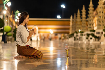 Portrait asian woman to paying respect to Buddha statue at Wat Suthat Thepwararam