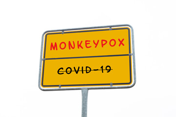 The word monkeypox is standing on a sign, outbreak of the MPXV virus, infectious disease spreading, Covid-19 pandemic is crossed out