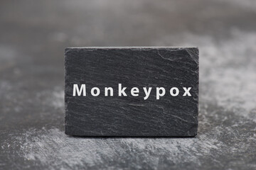 The word monkeypox is standing on a board, outbreak of the MPXV virus pandemic, infectious disease spreading
