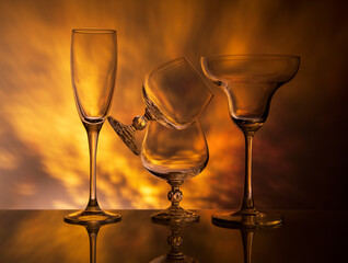 Glass goblets on colorful gradient background