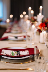 Autumn wedding table setting. Luxury stylish autumn wedding decor. Flowers and tableware on the wedding banquet. Styled romantic dinner in red color
